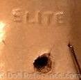Elite Creations doll mark ELITE, with a hole and staple.