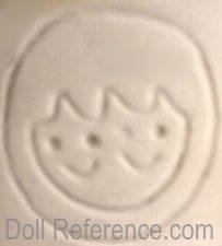 Porcelain doll mark circle witht wo smiling faces symbol, unknown
